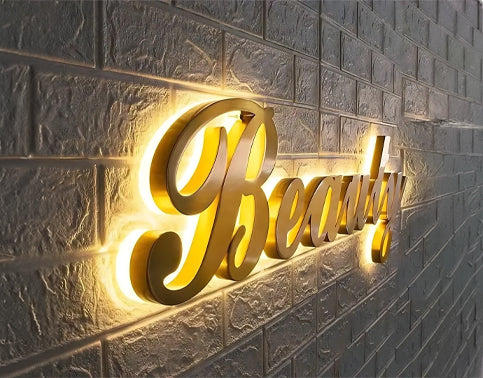 Halo-lit gold script lettering on a brick wall