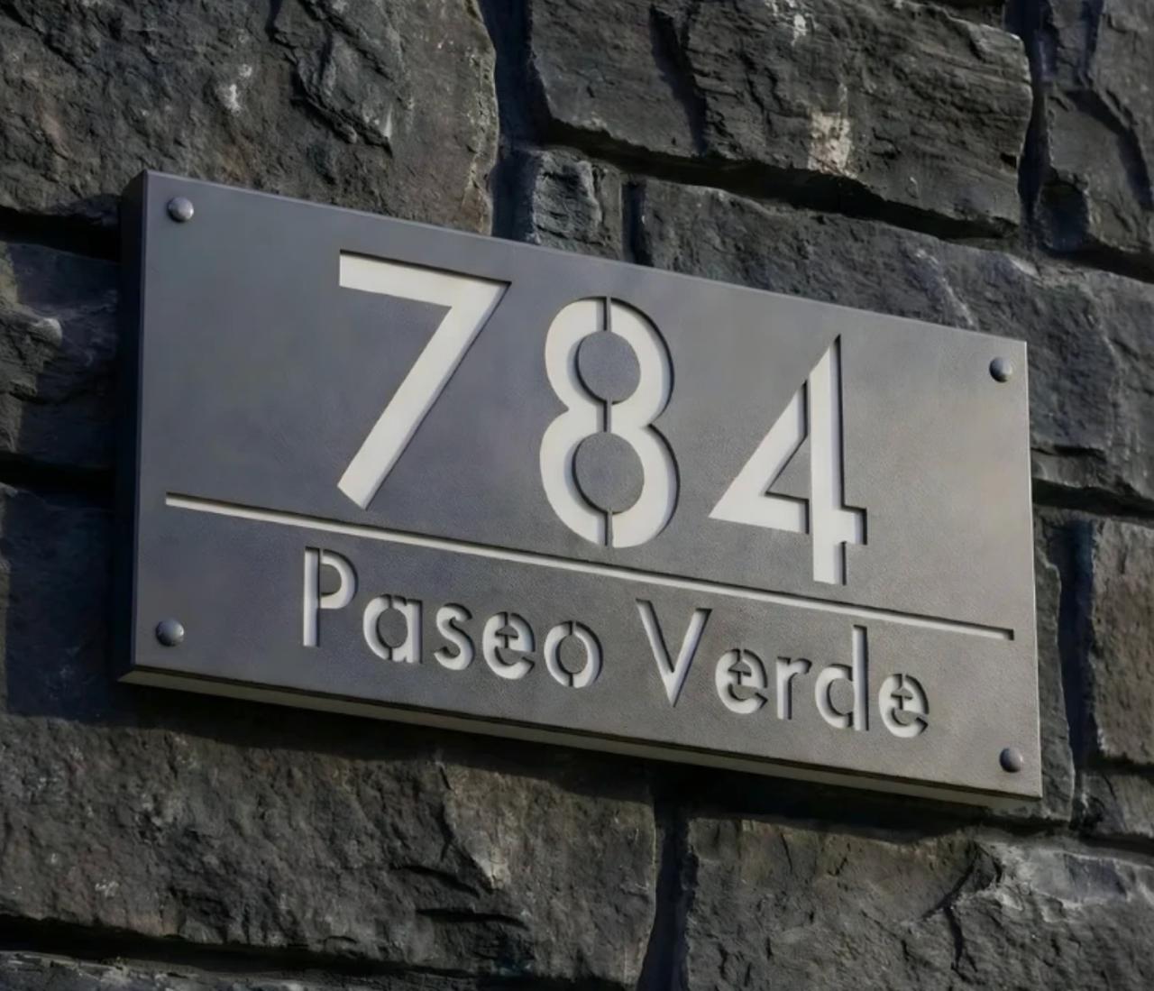 LED address plaque displaying 784 Paseo Verde on a stone wall